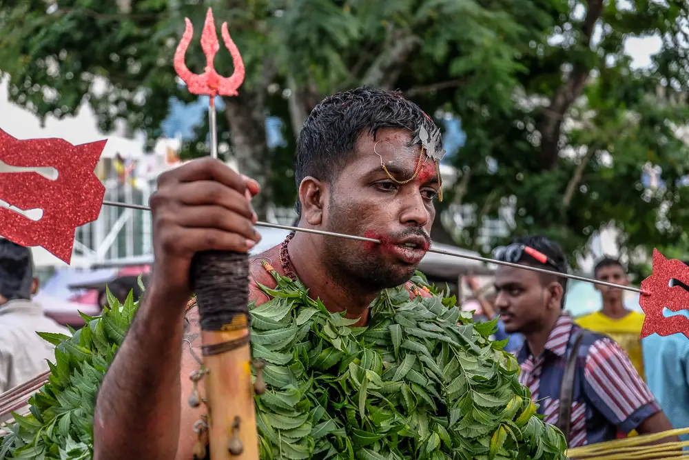 A kavadi bearer walks to the Waterfall temple