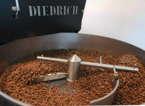 Frank Laurent Penang uses a Diedrich machine to roast international coffee beans