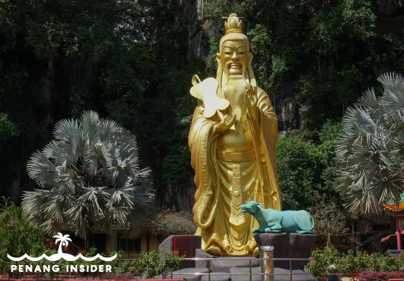 The golden Confucius statue in the front courtyard of Ipoh's Nam Thean Thong Cave Temple