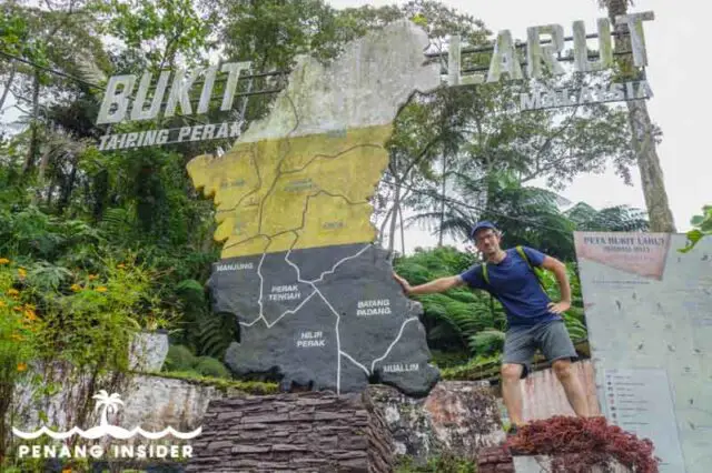 Marco Ferrarese stands next to Perak Bukit Larut sign in Taiping