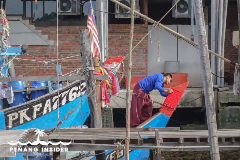 A man and his fishing boat in Kuala Sepetang