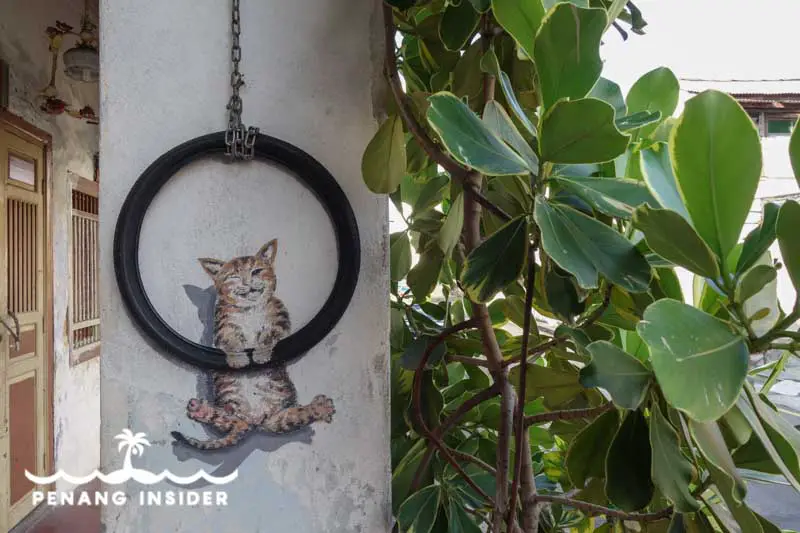 Penang Street Art Cat swinging inside a tyre