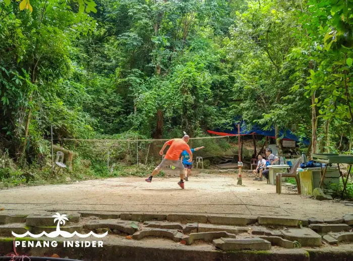 Locals play at the badminton court at the bottom of Bukit Hijau