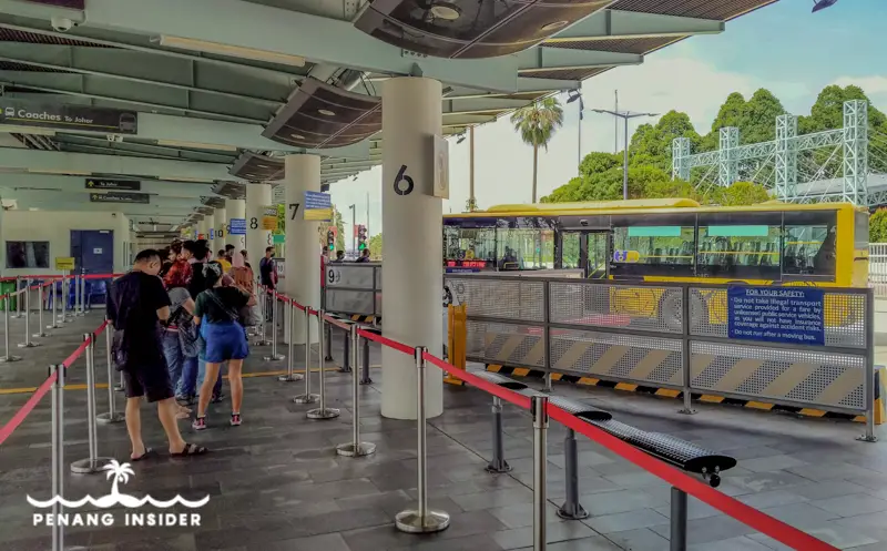 go to Malaysia from Singapore waiting in line for bus at Woodlands
